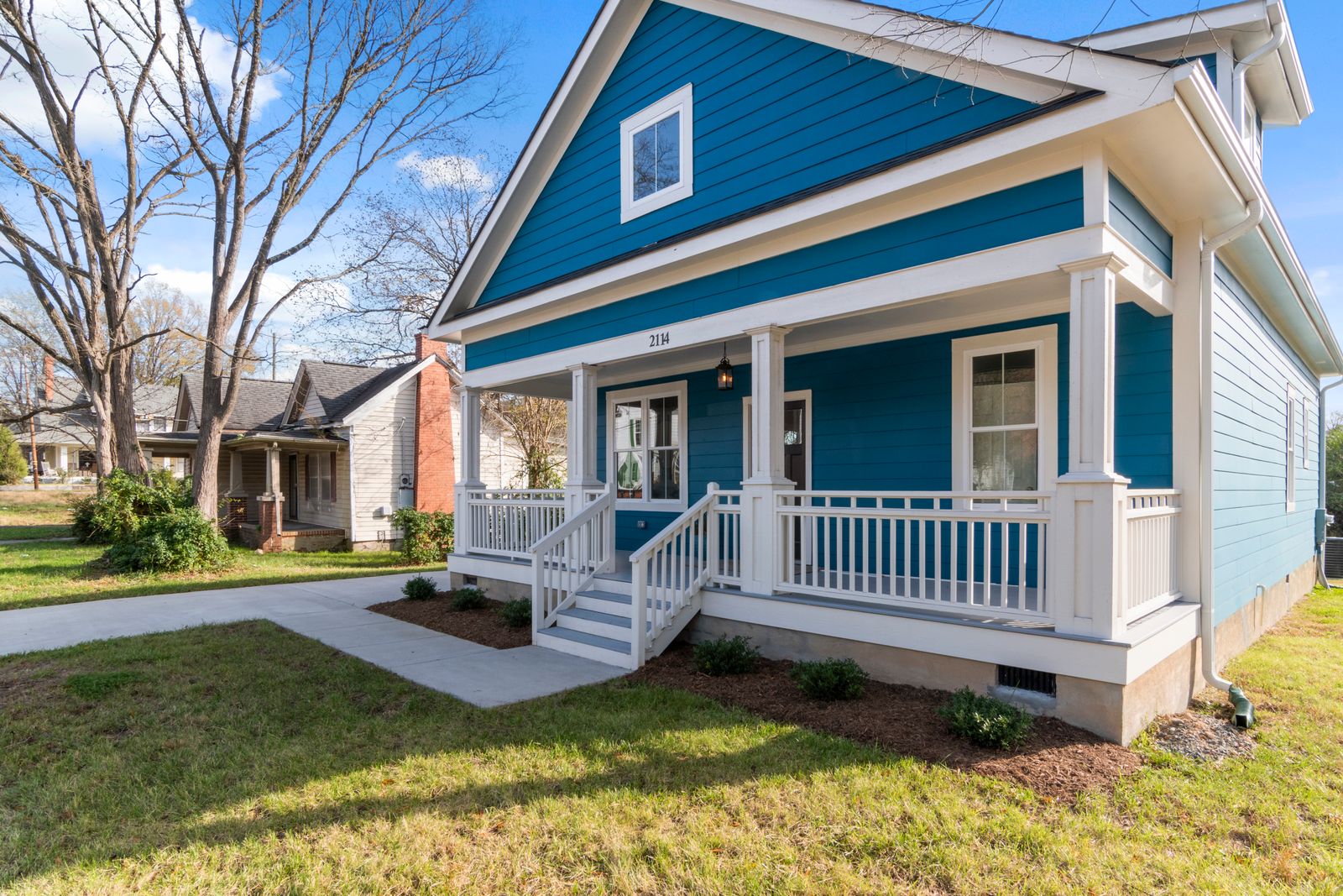 Coastal style home with white porch typical of the neighborhoods served by Timely Plumber